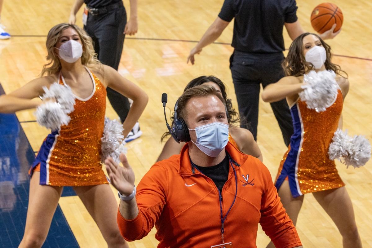 Dr. Tackitt conducting the HOOps Band as the UVA Dance Team breaks it down in the background.​ (Photo Credit: Tom Pajewski)