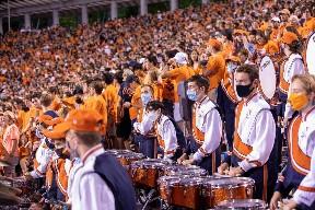 Members of the CMB drumline rest in between drum cadences at a recent home football game. Due to the risk of COVID, wind players are not permitted to play their instruments in the football stands. (Photo: Tom Pajewski)