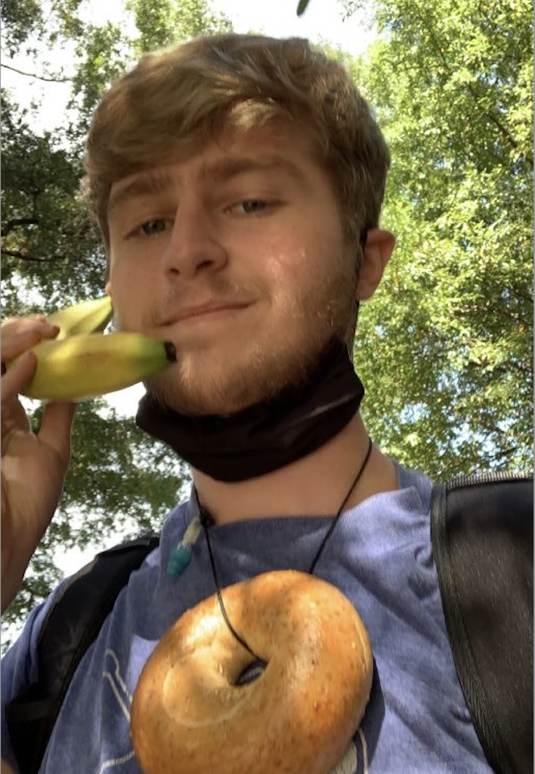 Nathan Snow wears a bagel necklace and holds a banana phone for a Sock Wars immunity. (Photo courtesy of student)